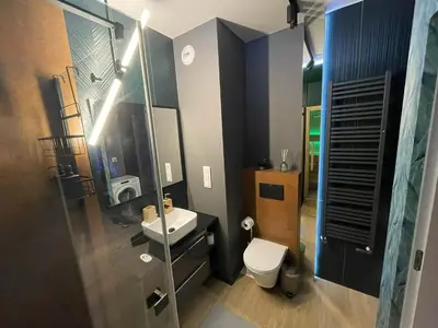 a shower with a glass door in a bathroom at New comfortable apartment with balcony and sauna on Klimieckiego street in Kraków