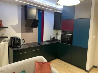 a living room with a couch and a flat screen tv at New comfortable apartment with balcony and sauna on Klimieckiego street in Kraków