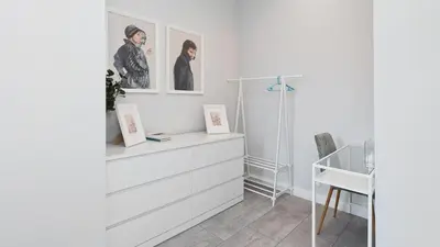 a room with white cabinets and pictures on the wall at Bogusławskiego , Sun & Snow in Kraków