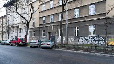 a building with cars parked on the side of the street at Bogusławskiego , Sun & Snow in Kraków