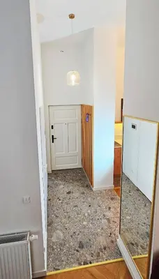 a room with a door and a mirror at Deluxe Vintage Chic Apartment - Kazimierz Old Town in Kraków