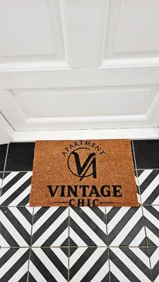 a welcome mat on a floor in a room at Deluxe Vintage Chic Apartment - Kazimierz Old Town in Kraków