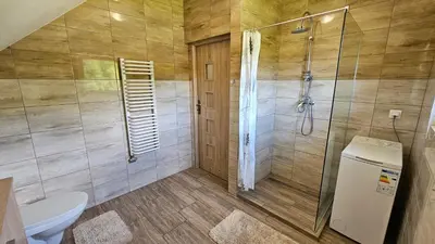 a bathroom with a shower and a toilet at BliżejGorców in Lubomierz