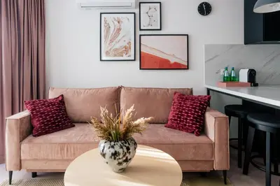 a living room with a couch and a table at Home From Home - Kraków, Podgórze in Kraków