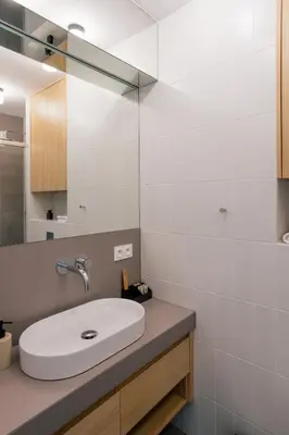 a white bathroom with a sink and a mirror at Home From Home - Kraków, Podgórze in Kraków