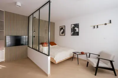 a bedroom with a bed and a desk and a chair at Home From Home - Kraków, Podgórze in Kraków