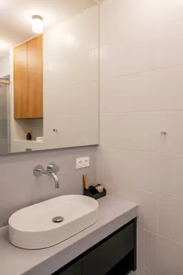 a white bathroom with a sink and a mirror at Home From Home - Kraków, Podgórze in Kraków