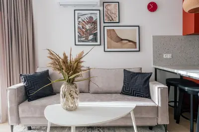 a living room with a couch and a table at Home From Home - Kraków, Podgórze in Kraków