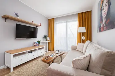 a living room with a couch and a flat screen tv at Prandoty Beautiful Apartment with Balcony Cracow by Renters Prestige in Kraków