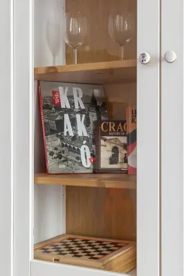 a book shelf with books and magazines on it at Prandoty Beautiful Apartment with Balcony Cracow by Renters Prestige in Kraków