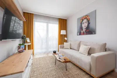 a living room with a couch and a table at Prandoty Beautiful Apartment with Balcony Cracow by Renters Prestige in Kraków