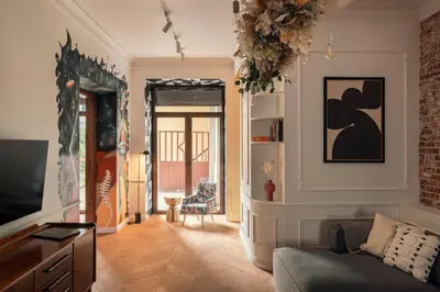 a living room with a couch and a television at Austin Flowers Old Town by WillyWalls in Kraków