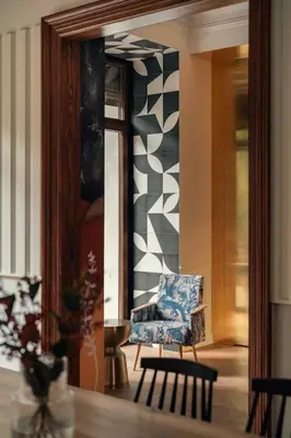 a living room with a chair and a mirror at Austin Flowers Old Town by WillyWalls in Kraków