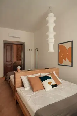 a bedroom with a large bed with white sheets at Austin Flowers Old Town by WillyWalls in Kraków