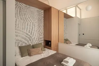 a small bedroom with a bed and a mirror at Austin Flowers Old Town by WillyWalls in Kraków