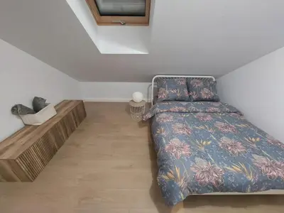 a bedroom with a bed and a wooden floor at Komfortowe mieszkanie, duży taras, bezpłatny parking, AWG APARTMENTS in Kraków