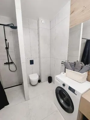 a bathroom with a shower and a toilet and a sink at Komfortowe mieszkanie, duży taras, bezpłatny parking, AWG APARTMENTS in Kraków