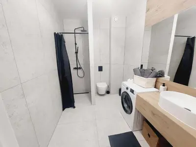 a bathroom with a sink and a toilet and a shower at Komfortowe mieszkanie, duży taras, bezpłatny parking, AWG APARTMENTS in Kraków