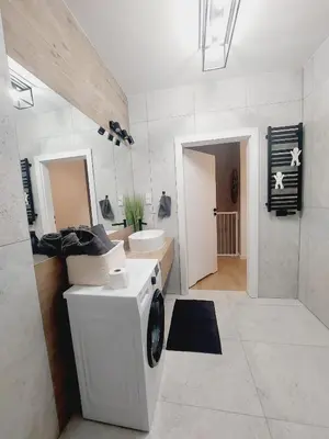 a laundry room with a washing machine and a sink at Komfortowe mieszkanie, duży taras, bezpłatny parking, AWG APARTMENTS in Kraków