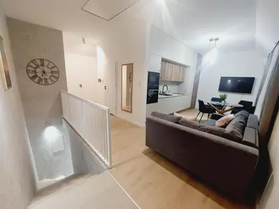 a living room with a couch and a table at Komfortowe mieszkanie, duży taras, bezpłatny parking, AWG APARTMENTS in Kraków
