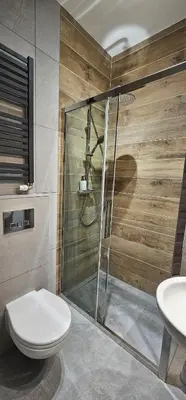 a bathroom with a shower and a toilet and a sink at Pawia Apartments Centrum in Kraków