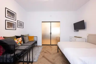 a living room with a couch and a tv at Native Apartments Pułaskiego 6 in Kraków