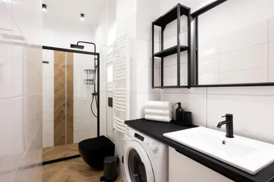 a white bathroom with a washing machine and a sink at Native Apartments Pułaskiego 6 in Kraków