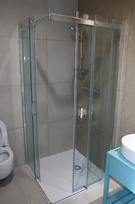 a glass shower stall in a bathroom with a toilet at Piotruś Pan in Brzesko