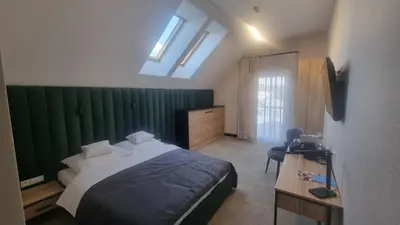 a bedroom with a bed and a green wall at Piotruś Pan in Brzesko