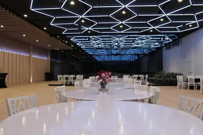 a banquet hall with white tables and white chairs at Piotruś Pan in Brzesko