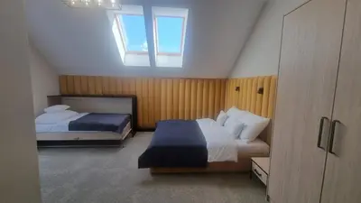 a bedroom with two beds and a window at Piotruś Pan in Brzesko