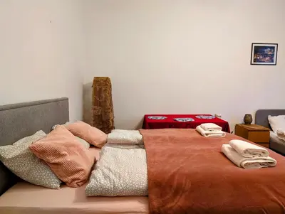 a bedroom with a bed with two towels on it at Aleja Krasińskiego 24A by Homeprime in Kraków