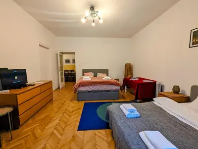 a bedroom with two beds and a flat screen tv at Aleja Krasińskiego 24A by Homeprime in Kraków