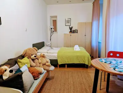 a bedroom with teddy bears sitting on a couch at Aleja Krasińskiego 24A by Homeprime in Kraków