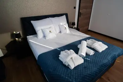 a bed with white towels and pillows on it at Owocowe Wzgórze in Tęgoborze