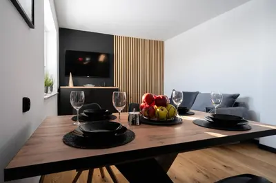 a dining room table with a bowl of fruit and wine glasses at Owocowe Wzgórze in Tęgoborze