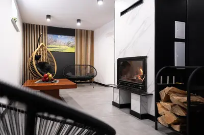 a living room with a fireplace and a television at Owocowe Wzgórze in Tęgoborze