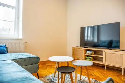 a living room with a couch and two tables at Sunny Corner in Kraków