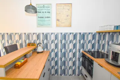 a kitchen with blue and white wallpaper and a counter at Sunny Corner in Kraków