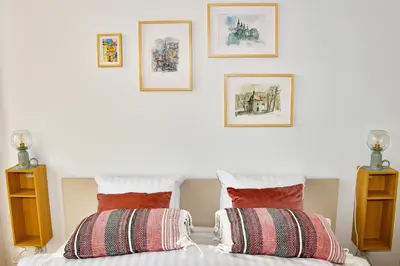 a white bedroom with two pillows on a bed at Sunny Corner in Kraków