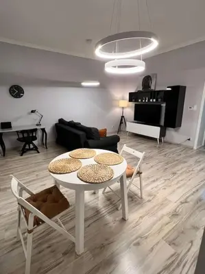 a living room with a white table and chairs at V&O Apartament in the centre of Krakow in Kraków
