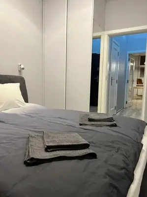 two towels are sitting on top of a bed at V&O Apartament in the centre of Krakow in Kraków