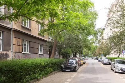 a street with cars parked on the side of the road at June B studio in Kraków