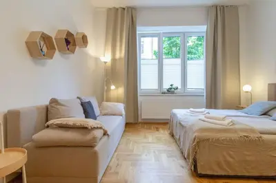 a living room with two beds and a couch at June B studio in Kraków