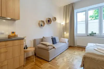a living room with a couch and a window at June B studio in Kraków