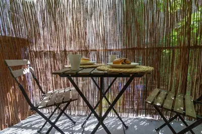 a table with a plate of food and two chairs at June C studio w/small balcony in Kraków