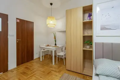a small room with a table and a bedroom at June C studio w/small balcony in Kraków