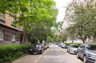a street with cars parked on the side of the road at June C studio w/small balcony in Kraków