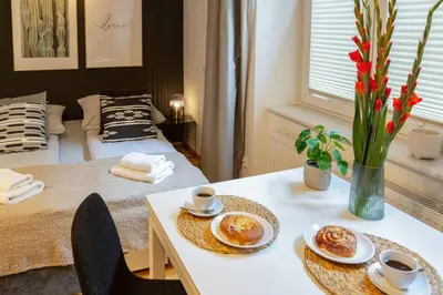 a room with a table with two plates of food on it at May A studio in Kraków
