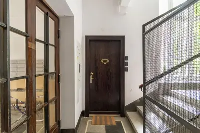 a wooden door in a room with a fence at May A studio in Kraków